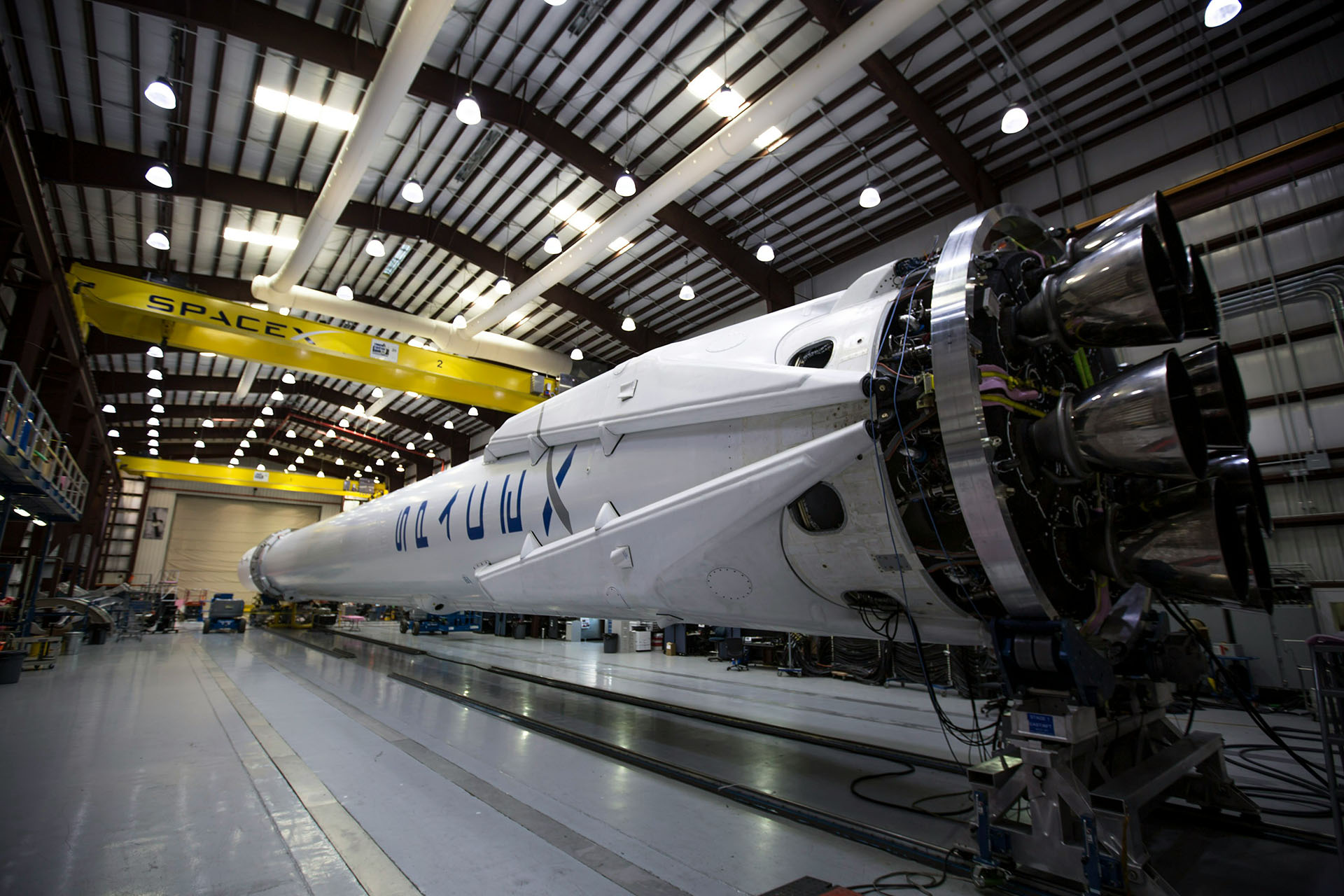 A SpaceX rocket in an enormous hangar.