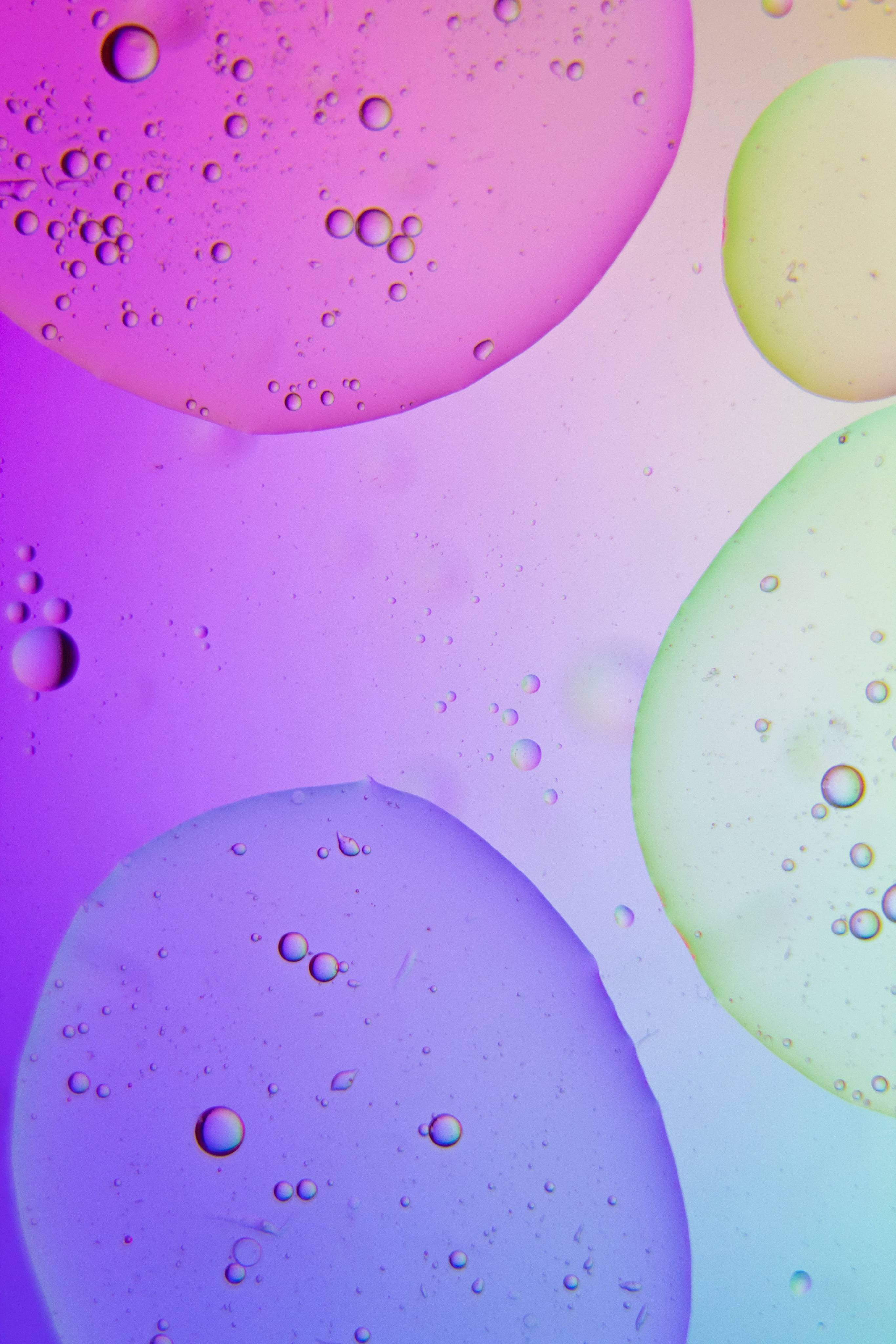 A slide depicting water droplets under different coloured lights.
