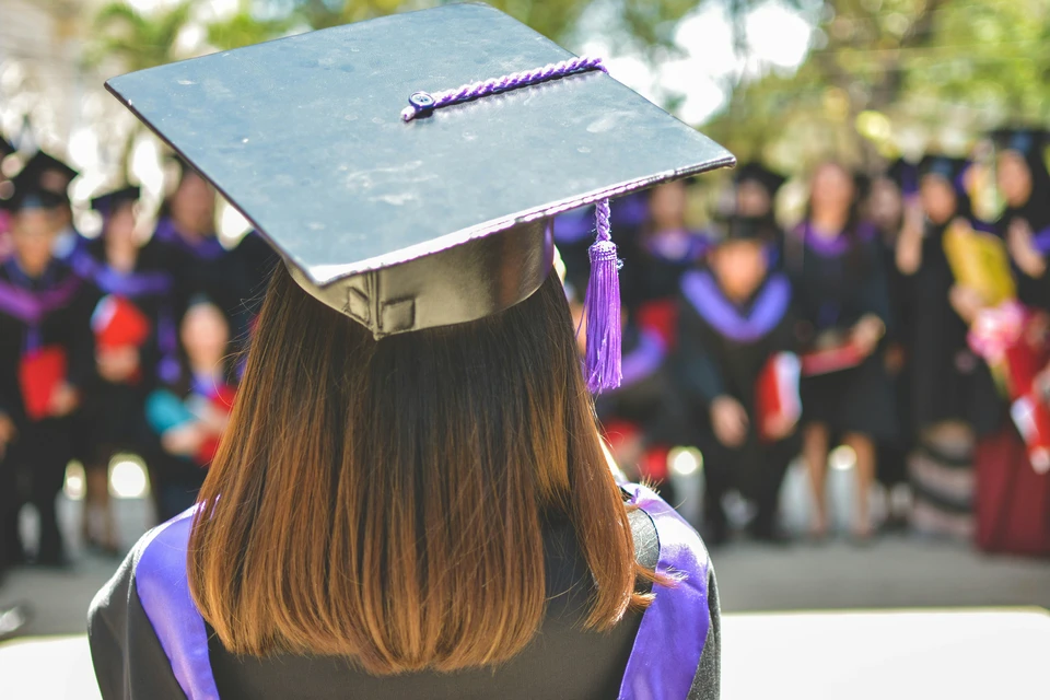 A shot from behind of a graduate wearing their mortar board.