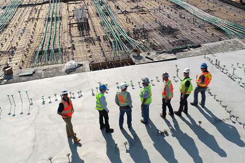 A group of engineers looking over a construction site.