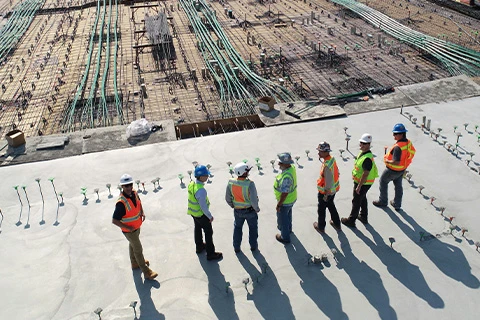 A group of engineers looking over a construction site.