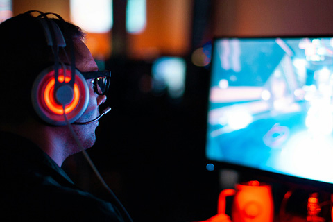 A person plays a game on a large monitor.