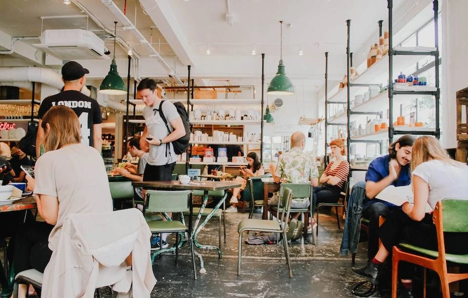 A group of students and staff inside a coffee shop.