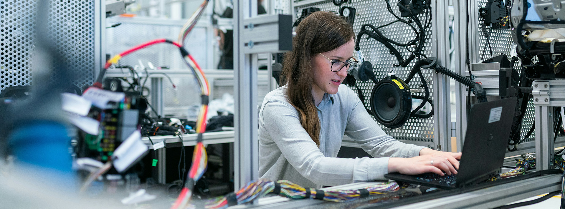 A student works at a laptop in a Mechanical Engineering laboratory.
