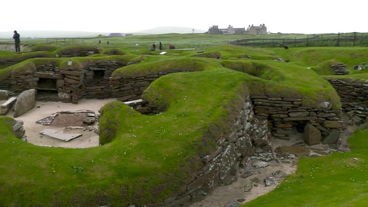 Skara Brae image from BBC Scotland A photo of Skara Brae showing the rolling green mounds and stone structures and doorways.